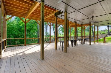 800 square foot covered basement walk out deck with a custom bar top and bar stools