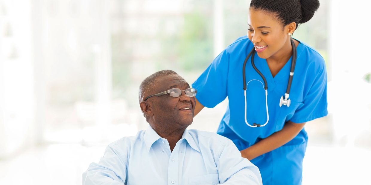 Nurse pushing man in a wheelchair
