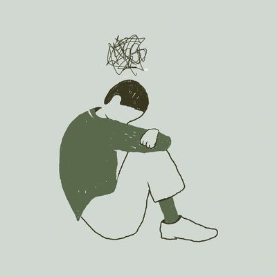 An image of someone looking sad, huddled on the floor and withdrawn.