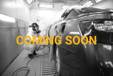 Master painter spraying in spray booth