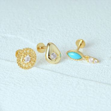 Three elegant gold stud earrings with diamond and turquoise details.