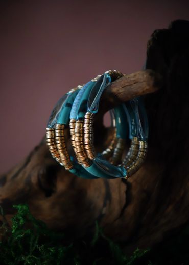Elegant blue and gold bracelet displayed on rustic wood.