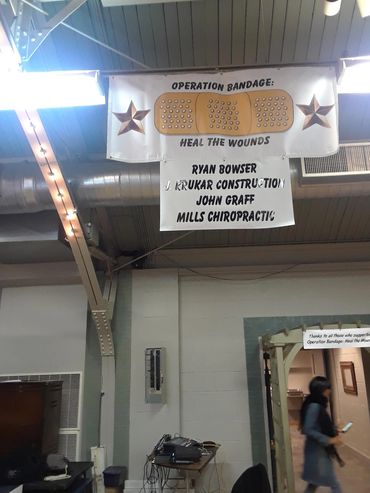 A banner for Operation Bandage: Heal the Wounds with sponsors' names.