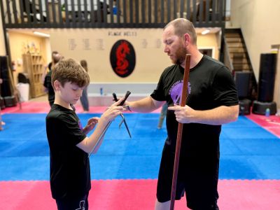 father and son training with sai at douglas martial arts in moose jaw