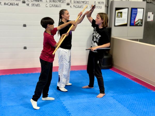 instructor teaching how to use sai at douglas martial arts in moose jaw