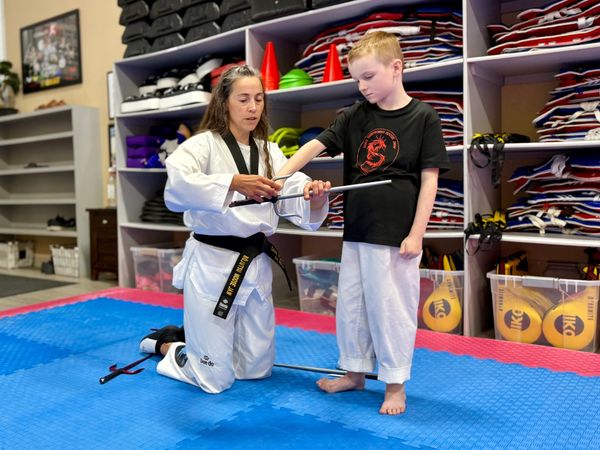 saijutsu instructor teaching how to grip sai at douglas martial arts in moose jaw