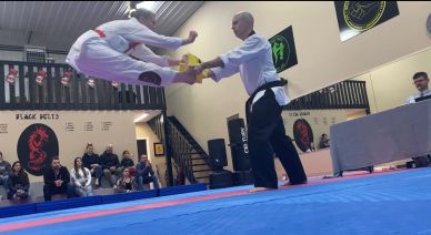 taekwondo student performing an impressive board break at douglas martial arts in moose jaw
