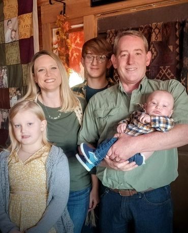 photo of our homeschool family parents and three children