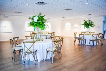 Ferns from the local florist spice up this event center. Simplistic wedding decor for this party.