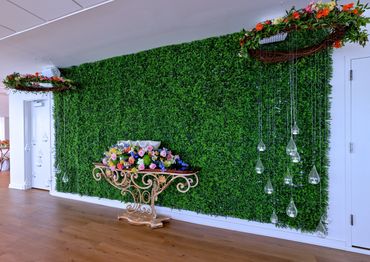 A green wall is a perfect wedding backdrop for photos for the bridal party. Tea light candles