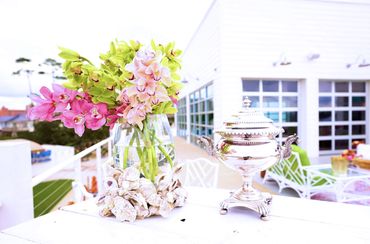 Oyster shells and flowers are set up on this outside bar. Let the bartender pour you some champagne