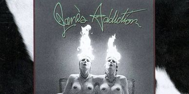 Cover art for Jane's Addiction's "Nothing Shocking" shows naked female conjoined twins sitting on a 
