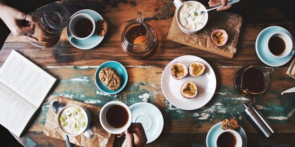 A small group around a table of refreshments