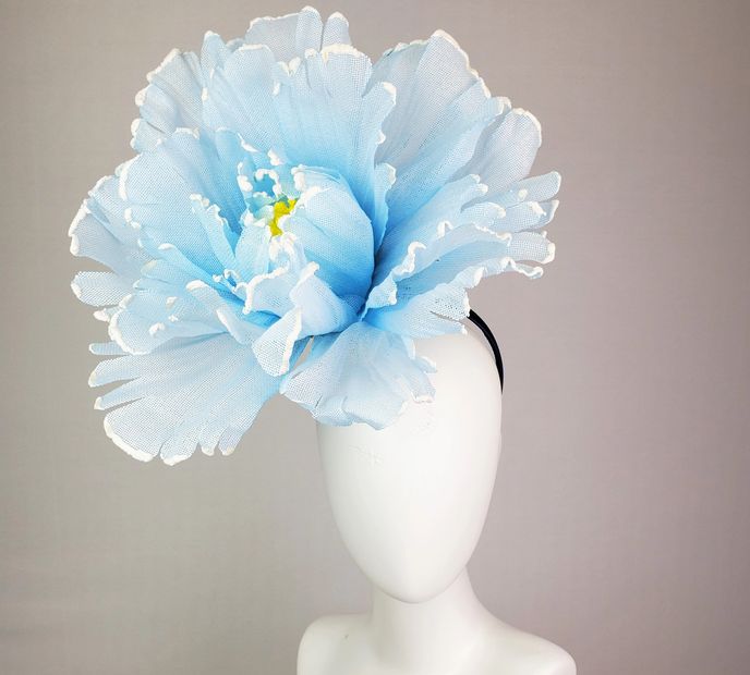 A Blue Color Flower Placed in a White Vase