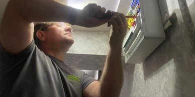 Man fixing a fuse box.