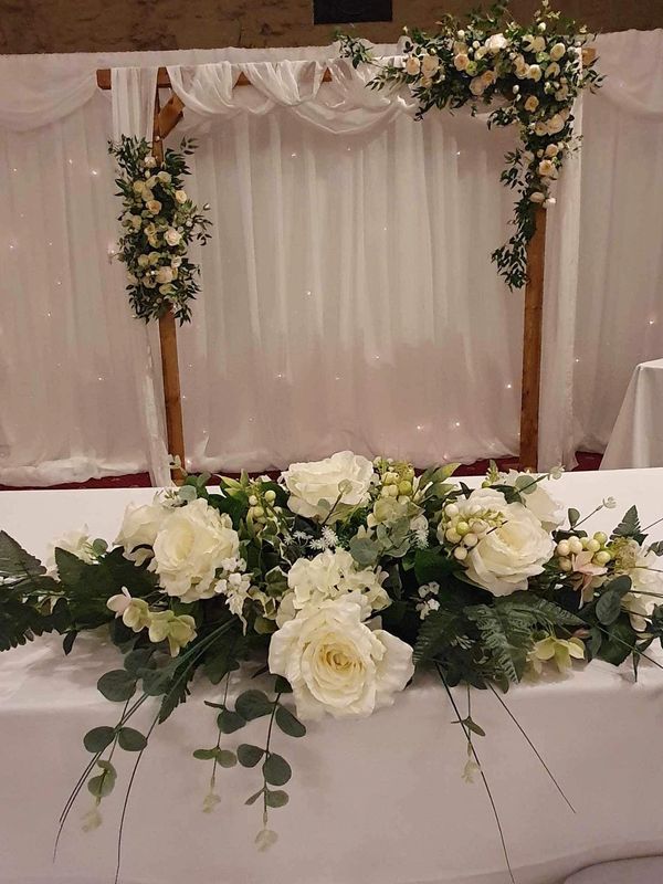 Wooden arbor backdrop, can be hired plain or with drape and floral decor