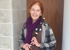 Woman holding the baroque flute she uses to provide Live Therapeutic Music to infants in Neonatal Intensive Care Uhits