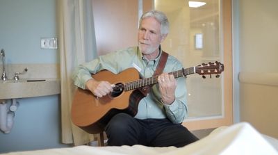 Certified Music Practitioner playing Live Therapeutic Music at the bedside of a hospital patient