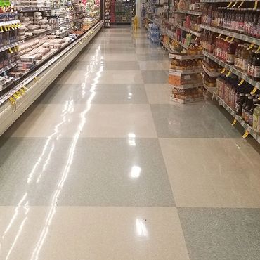 Grocery store aisle with very shiny floors, after being stripped and waxed.