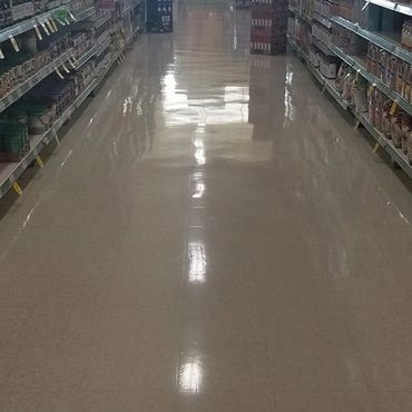 Grocery store aisle with very shiny floors, after being stripped and waxed.