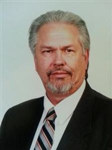 An older man in a business suit.