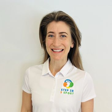 Smiling woman in a white polo with a colorful Step In 2 Sport logo.