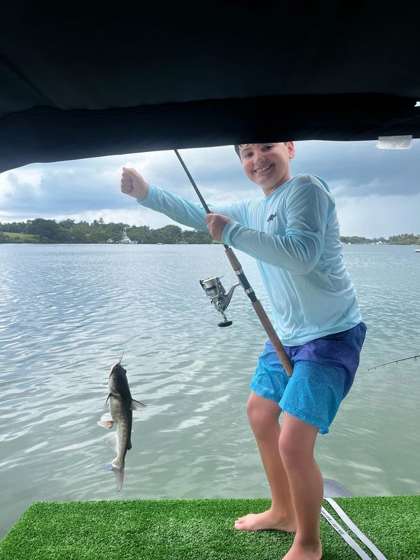 boy fishing in jupiter inlet, pontoon boat fishing, family day out