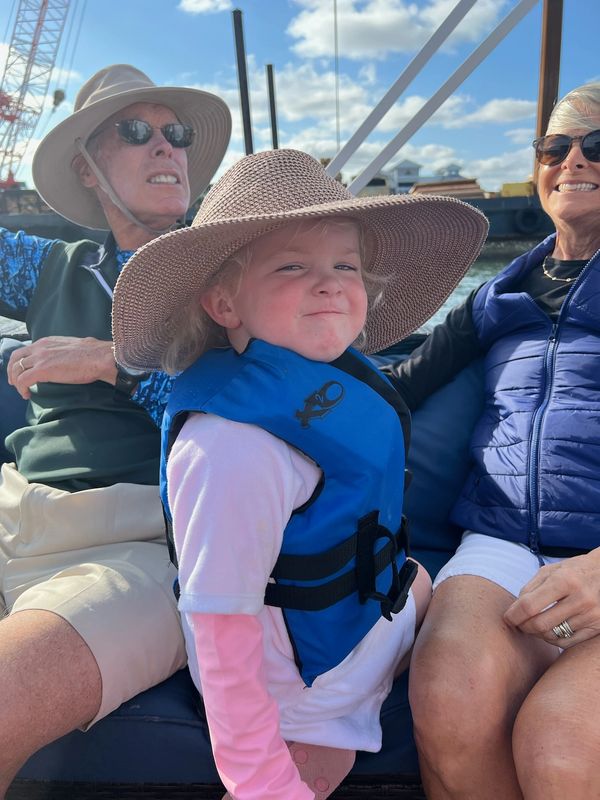 little girl, straw hat, life jacket, boat day, day cruise, family trip