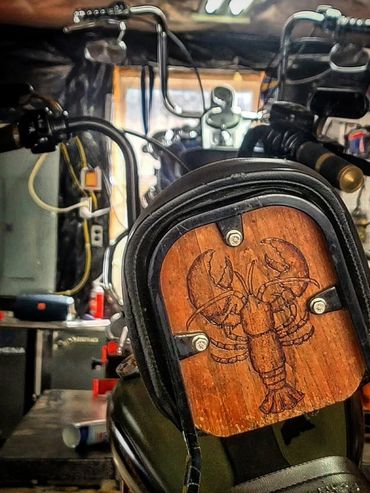 "In house" custom woodburned sissy bar.