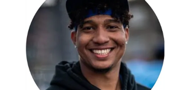 headshot of a man wearing a cap and smiling