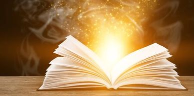 Open book, Open Bible with light rising out of it. The light of God's love is available to all.