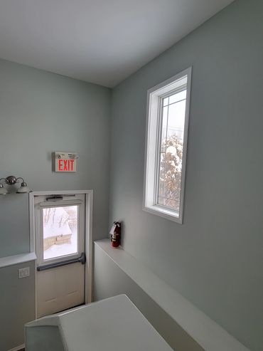 Interior painting completed in a stairwell exit