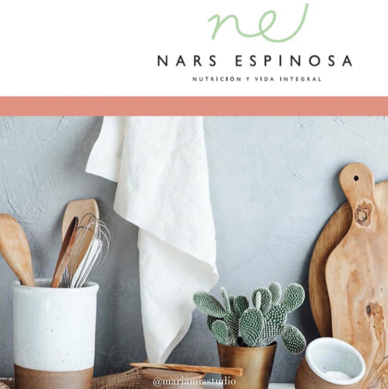 Minimalist kitchen setup with wooden utensils, cactus plant, and cutting boards.