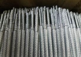 1/16" galvanized coated to 1/8" with clear PVC, cut and stripped