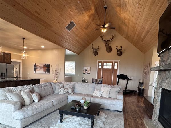 Cozy living room with a large sectional sofa and rustic decor.