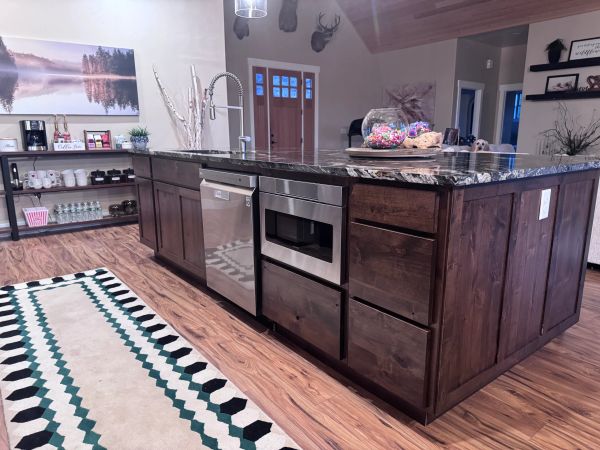Modern kitchen island with dark wood cabinets and granite countertop.