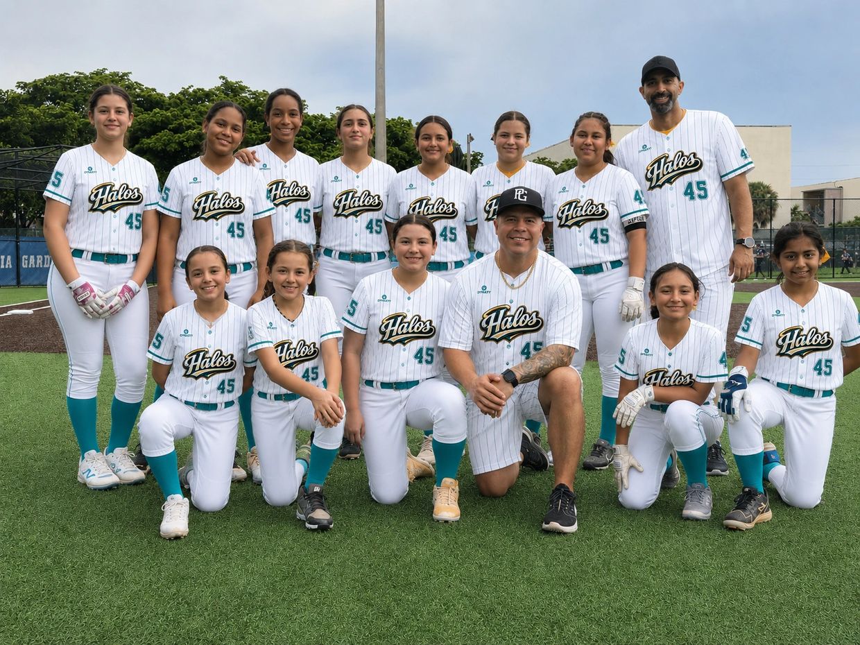 A youth softball team in white "Halos" uniforms posing on a field.