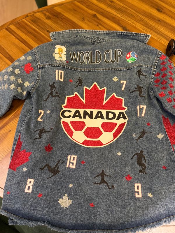 Denim jacket with Canada World Cup soccer design.