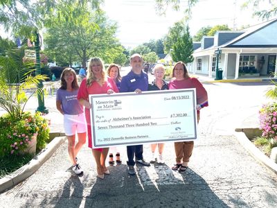 Zionsville business owners present a check to the Alzheimer's Association.