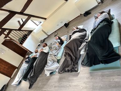 Staff from Rebus Mortgage Advisors lying down on yoga mats for a relaxation session