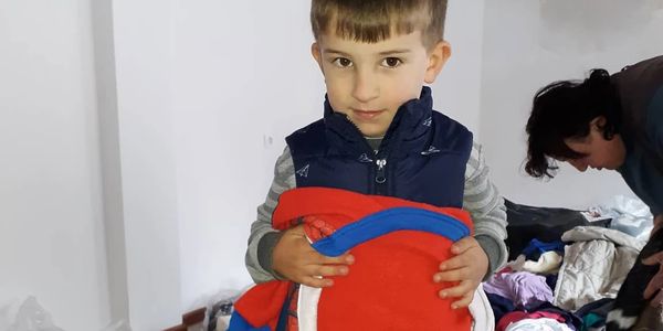 A georgian boy clinging to a found spiderman costume.