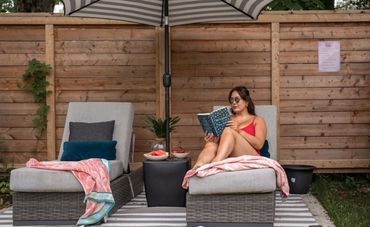 Women sit on the lounge chairs