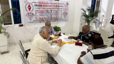 Four men playing bridge at a Bridge Association event.