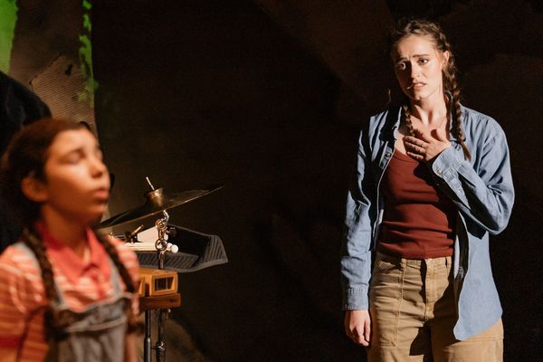 Two women in a dramatic scene, one looking emotional.