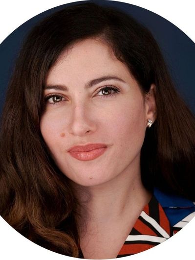 Portrait of a woman with long hair and a confident expression.