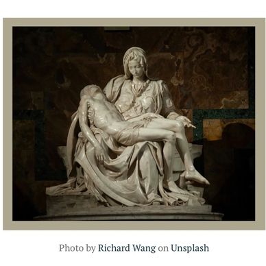 Marble sculpture of a woman holding a man.