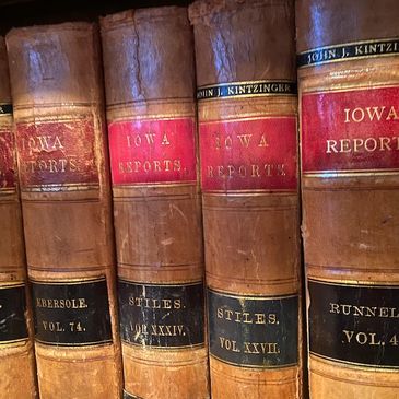 Close-up of vintage leather-bound Iowa Reports law books on a shelf.