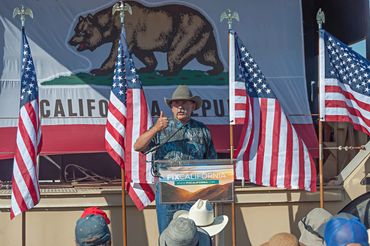 Sam Paredes Executive Director of Gun Owners of America gives speech. to a crowd..