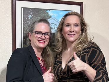 Chairwoman, Michele Guerra on left and Jessie Jane Duff  on right and they both  a thumbs up.