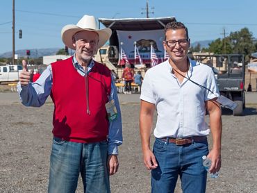 Joshua Scott, assistant to Ambassador Ric Grenell on the right and on the left is a guest.